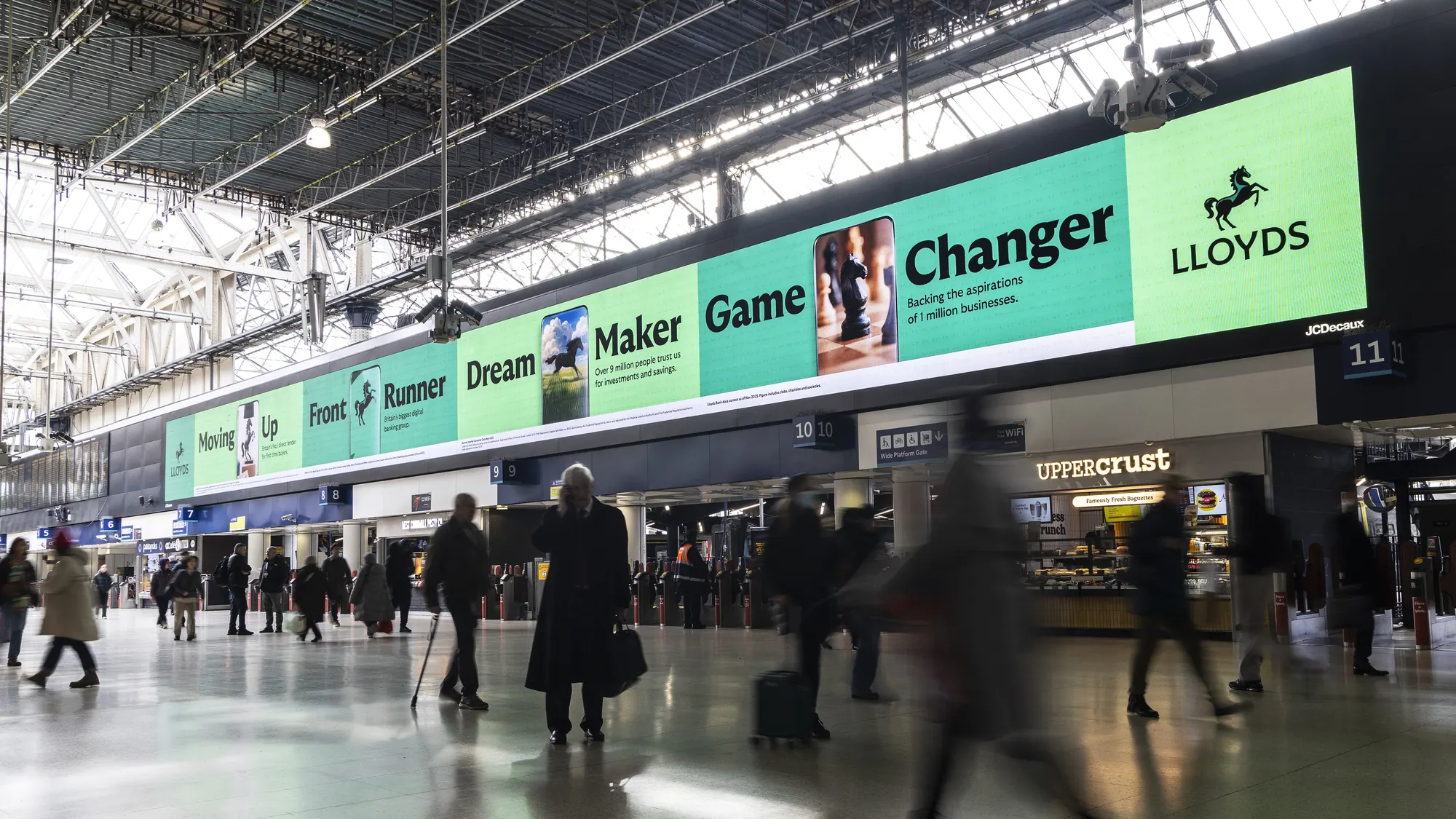 The animations on the long screen above Waterloo station concourse